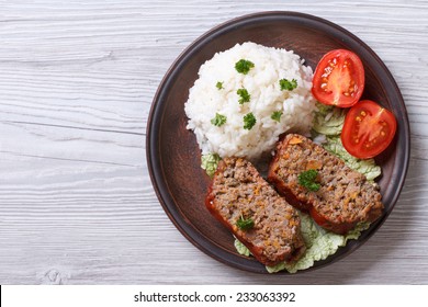 Delicious Meat Loaf With Rice On A Plate On The Table, A Horizontal Top View 