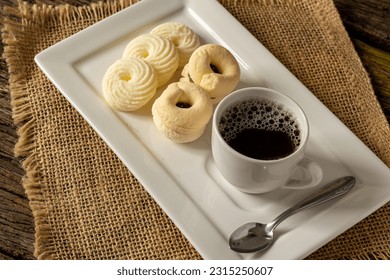 

Delicious mini butter flavored milk and guava cookies with a cup of coffee served in elegant jars on top of a rustic wood or white marble table, top view and selective focus - Shutterstock ID 2315250607