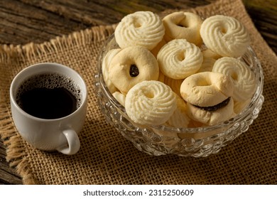 

Delicious mini butter flavored milk and guava cookies with a cup of coffee served in elegant jars on top of a rustic wood or white marble table, top view and selective focus - Shutterstock ID 2315250609