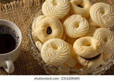 

Delicious mini butter flavored milk and (Sequilhos) guava cookies with a cup of coffee served in elegant jars on top of a rustic wood or white marble table, top view and selective focus - Shutterstock ID 2316200685