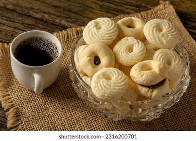 

Delicious mini butter flavored milk and (Sequilhos) guava cookies with a cup of coffee served in elegant jars on top of a rustic wood or white marble table, top view and selective focus - Shutterstock ID 2316200701