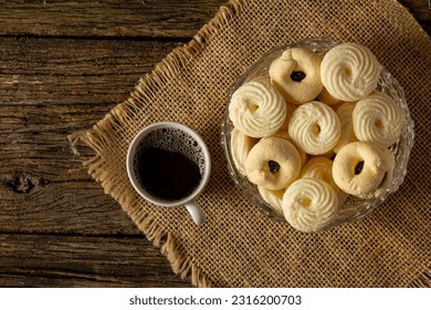 

Delicious mini butter flavored milk and (Sequilhos) guava cookies with a cup of coffee served in elegant jars on top of a rustic wood or white marble table, top view and selective focus - Shutterstock ID 2316200703