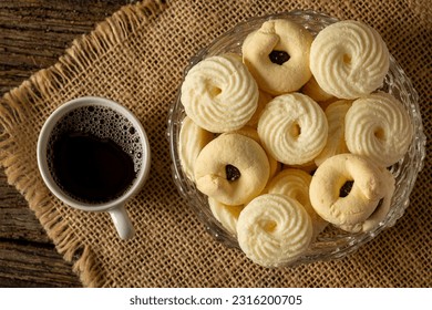 

Delicious mini butter flavored milk and (Sequilhos) guava cookies with a cup of coffee served in elegant jars on top of a rustic wood or white marble table, top view and selective focus - Shutterstock ID 2316200705