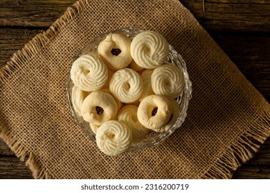 

Delicious mini butter flavored milk and (Sequilhos) guava cookies with a cup of coffee served in elegant jars on top of a rustic wood or white marble table, top view and selective focus - Shutterstock ID 2316200719