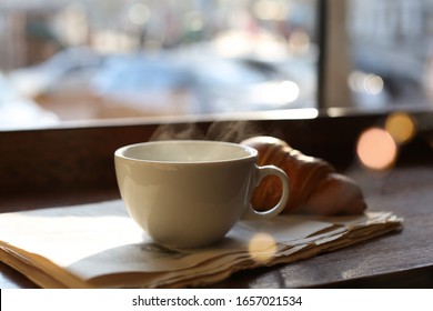 Delicious Morning Coffee, Newspaper And Croissant Near Window, Indoors