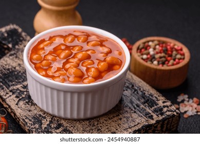 Delicious nutritious canned beans in tomato, with salt and spices as a high-calorie breakfast addition