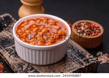 Delicious nutritious canned beans in tomato, with salt and spices as a high-calorie breakfast addition