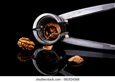 Delicious nuts and nutcrackers on a black background