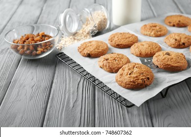 Delicious oatmeal cookies with raisins on wooden table