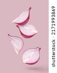 Delicious onions, flying in the air,  isolated on pastel magenta background