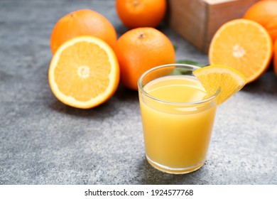 Delicious Orange Juice And Fresh Fruit On Grey Table. Space For Text