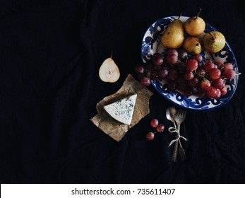 Delicious organic blue cheese/Roquefort cheese with fresh pears, grapes and honeycomb. Vintage silver spoons, black fabric. Fruits, cheese. Delicacy food. Snack/appetizer. Top view. Space for text - Shutterstock ID 735611407