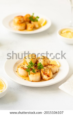 Delicious organic scallops with butter sauce and lemon. Restaurant menu