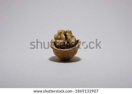 Delicious organic walnut with nutshell  isolated on a white background