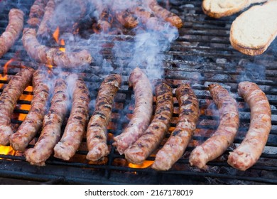 Delicious Outdoor Eating. Appetizing Sausages Grilling On Portable Bbq..