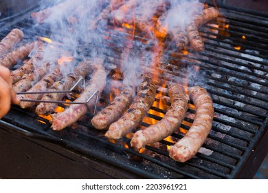 Delicious Outdoor Eating. Appetizing Sausages Grilling On Portable Bbq..