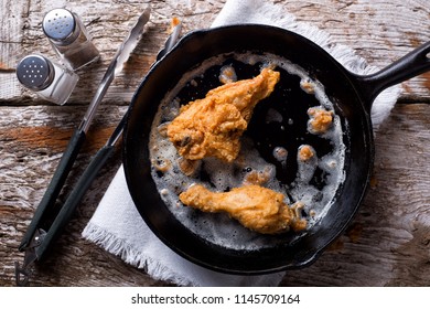 Delicious Pan Fried Chicken In A Cast Iron Frying Pan.