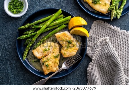 Delicious pan seared halibut with lemon butter sauce and asparagus.