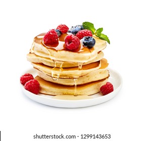 Delicious pancakes with berries, honey or maple syrup. Homemade pancakes and sweet syrup on white plate isolated. - Powered by Shutterstock