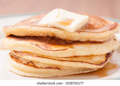 delicious pancakes in a stack with melting butter and maple syrup