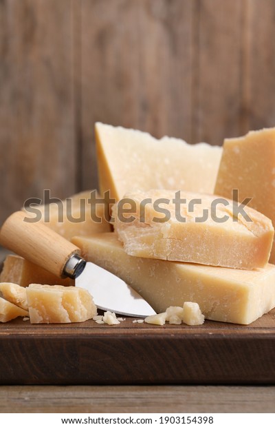 Delicious\
parmesan cheese with knife on wooden\
table