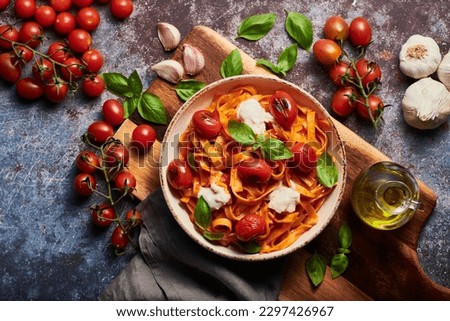 Delicious pasta dish with tomatoes and fresh basil. 