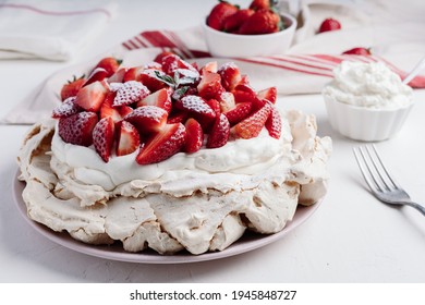 Delicious Pavlova cake dessert with fresh strawberry. White and red dessert