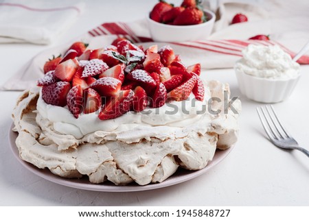 Delicious Pavlova cake dessert with fresh strawberry. White and red dessert