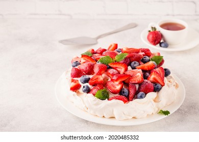 Delicious Pavlova cake with fresh strawberry and blueberry, selective focus