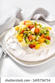 Delicious Pavlova Meringue Cake With Kiwi, Mango, Pineapple, Blood Orange Slices And Whipped Cream. Selective Focus.