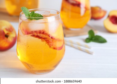 Delicious Peach Lemonade Made With Soda Water On White Wooden Table, Closeup. Space For Text