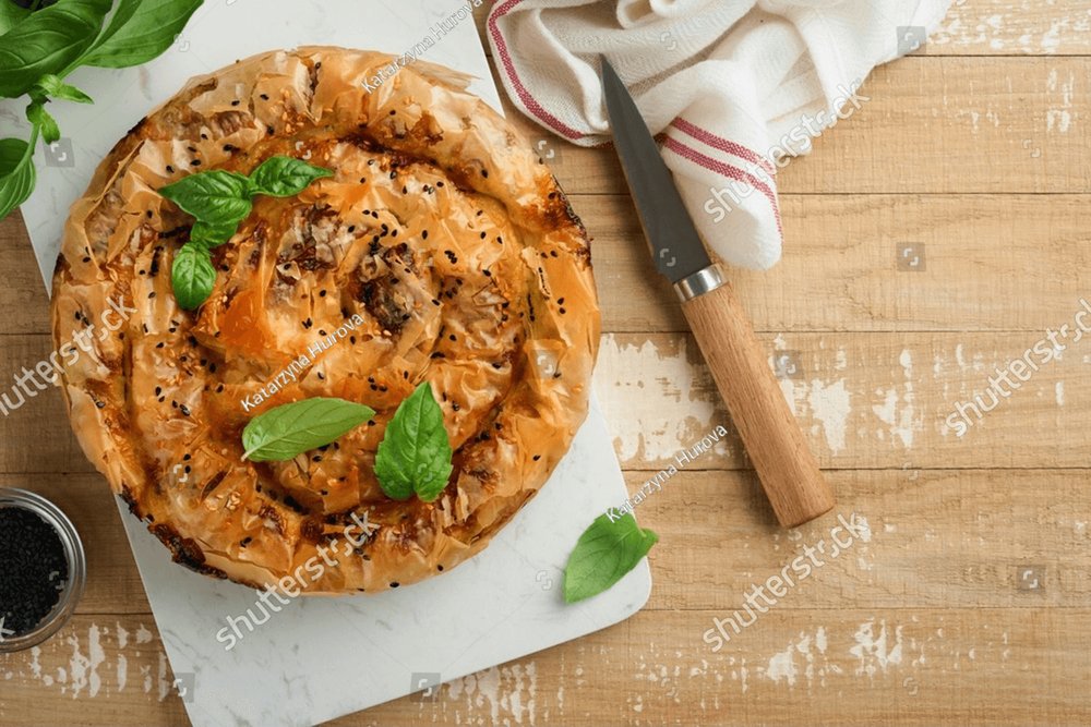 Delicious pie Spanakopita with soft feta cheese and spinach on old ...