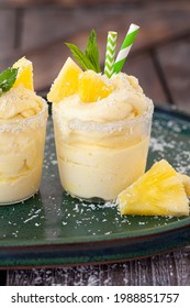 Delicious pineapple soft serve with coconut flakes and mint leaves