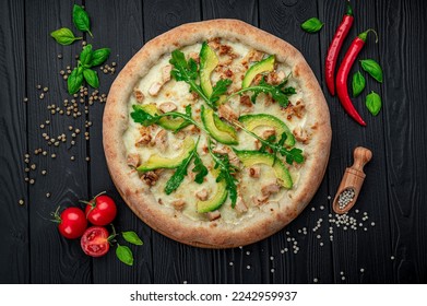 Delicious pizza with grilled chicken, avocado, and arugula. Top view of big pizza - Powered by Shutterstock