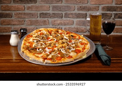 A delicious pizza with mushrooms, pepperoni, and onions served with a mug of beer and a glass of red wine on a wooden table in a cozy restaurant. - Powered by Shutterstock