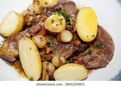 A Delicious Plate Of Chicken Coq Au Vin With Potatoes