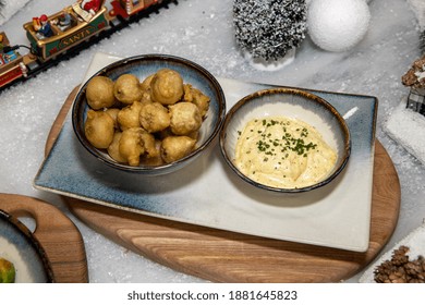 A Delicious Plate Of Cooked Deep Fried Brussels Sprouts On A Christmas Themed Background