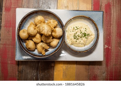 A Delicious Plate Of Cooked Deep Fried Brussels Sprouts On A Wooden Background