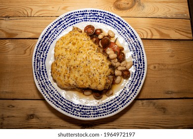 A Delicious Plate Of A Rarebit Pork Chop With Summer Bean Salad On A Wooden Kitchen Table 