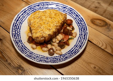 A Delicious Plate Of A Rarebit Pork Chop With Summer Bean Salad On A Wooden Kitchen Table 