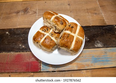 A Delicious Plate Of Three Hot Cross Buns On A Kitchen Table