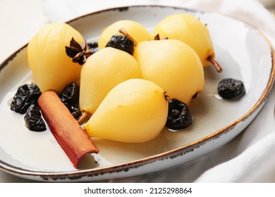 Delicious poached pears, prunes, anise and cinnamon on table, closeup