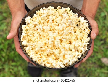 Delicious Popcorn In Bowl On Hand