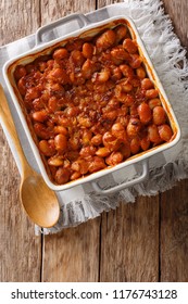 Delicious Prebranac Baked Beans With Onions Close-up In A Baking Dish On A Table. Vertical Top View From Above
