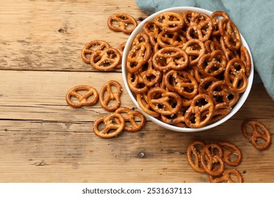 Delicious pretzel crackers on wooden table, flat lay - Powered by Shutterstock