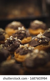 Delicious profiteroles with chocolate and nuts, selective focus image.