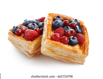 Delicious puff pastries with berries on white background - Shutterstock ID 665710798