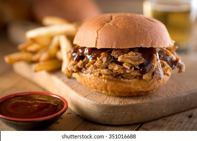 A Delicious Pulled Pork Sandwich With Barbecue Sauce On A Bun.