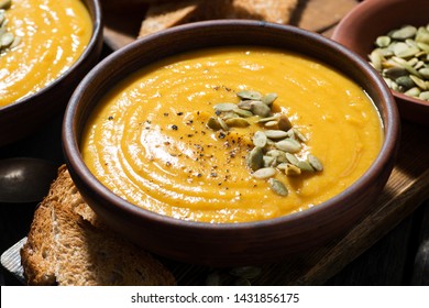 Delicious pumpkin soup in a bowl, closeup, horizontal