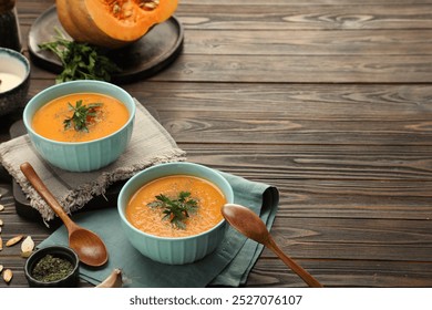 Delicious pumpkin soup and spices on wooden table. Space for text - Powered by Shutterstock